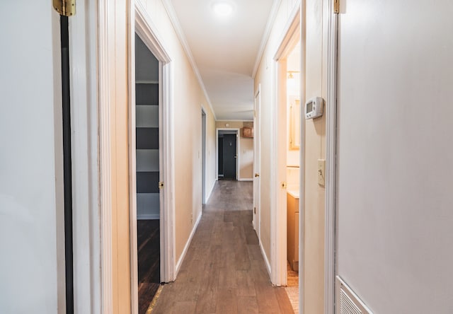 corridor featuring hardwood / wood-style flooring and crown molding