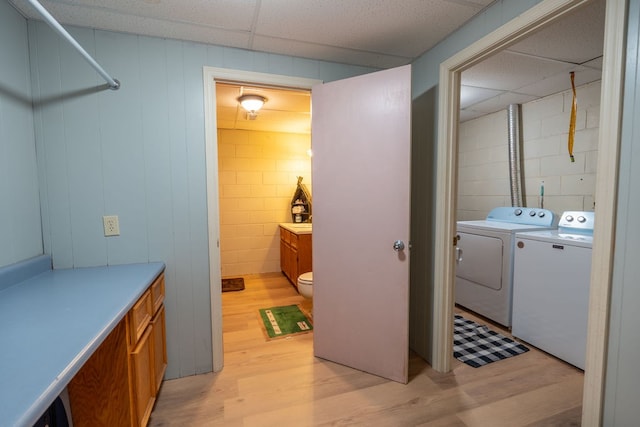 washroom featuring washer and dryer and light hardwood / wood-style floors