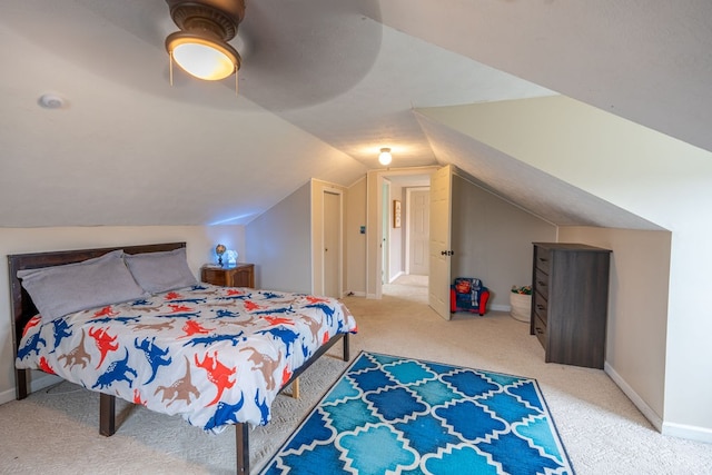 carpeted bedroom with ceiling fan and vaulted ceiling