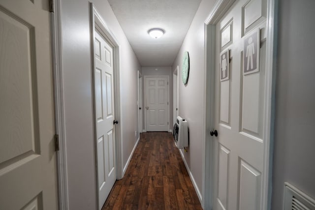 hall featuring heating unit and dark wood-type flooring