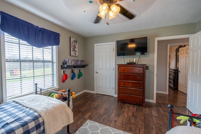 bedroom with dark hardwood / wood-style flooring and ceiling fan