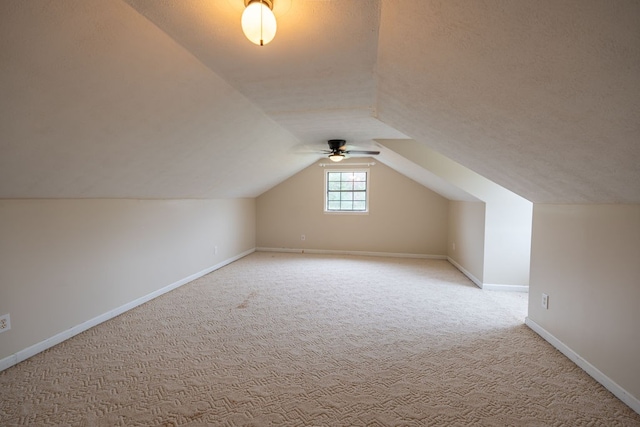 bonus room featuring ceiling fan, carpet floors, and vaulted ceiling