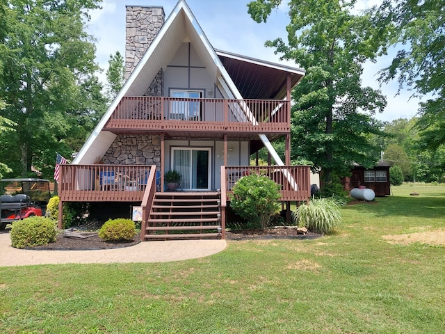 back of house featuring a lawn and a wooden deck