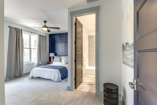 bedroom featuring connected bathroom, ceiling fan, and light colored carpet