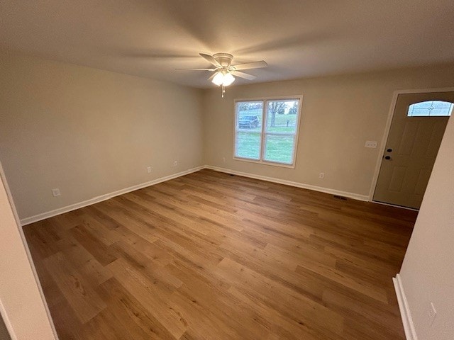 empty room featuring hardwood / wood-style floors and ceiling fan