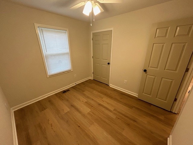 unfurnished bedroom with ceiling fan and light hardwood / wood-style flooring