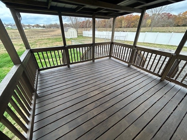 wooden terrace with a water view and a storage unit