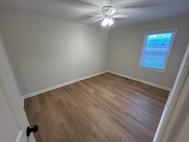 unfurnished room with light wood-type flooring and ceiling fan