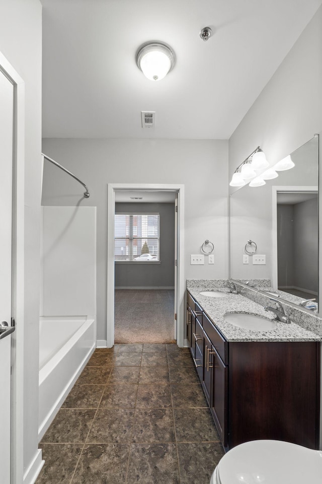 full bath featuring visible vents, a sink,  shower combination, double vanity, and baseboards