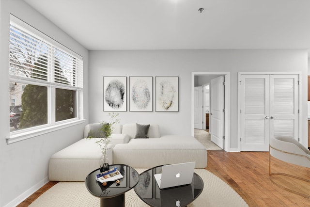 bedroom featuring a closet, baseboards, and wood finished floors