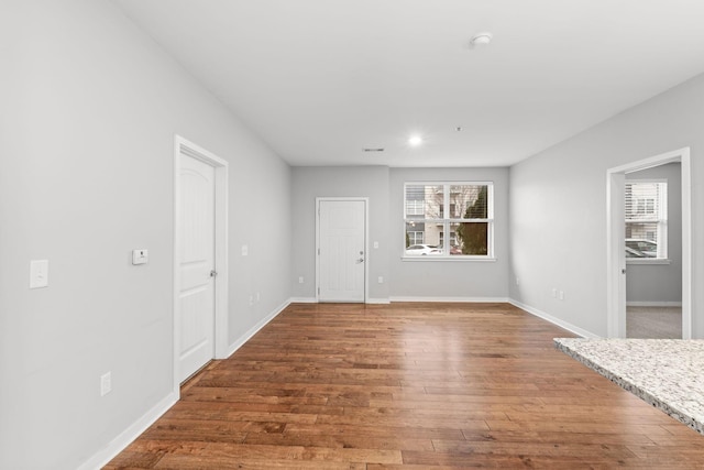 interior space with baseboards and wood finished floors