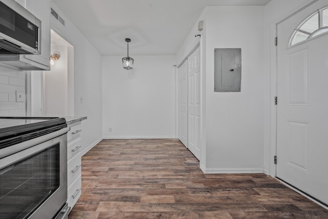 kitchen with stainless steel appliances, dark wood-type flooring, pendant lighting, electric panel, and white cabinetry