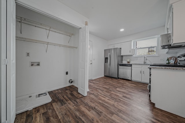 kitchen with appliances with stainless steel finishes, dark hardwood / wood-style flooring, tasteful backsplash, sink, and white cabinetry