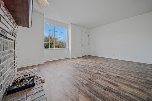 unfurnished living room featuring wood-type flooring