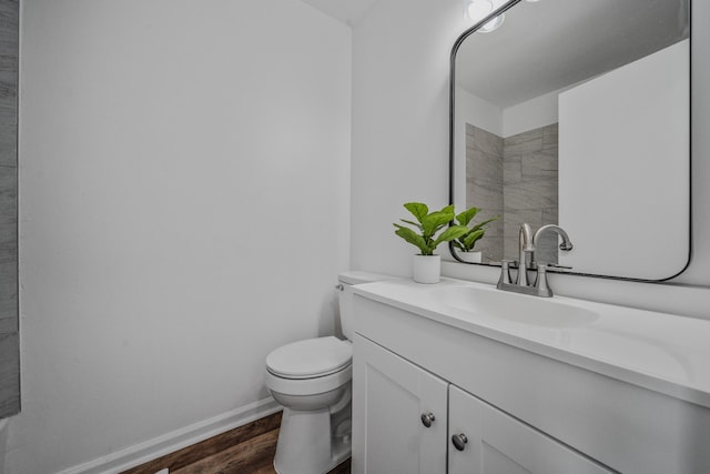 bathroom with vanity, hardwood / wood-style flooring, and toilet