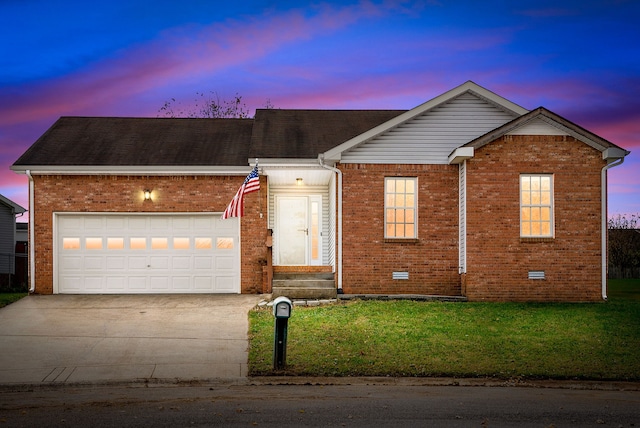 view of front of home featuring a garage and a yard