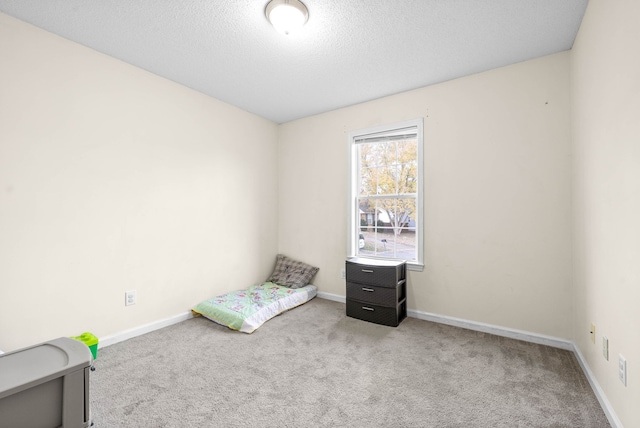 unfurnished bedroom featuring carpet flooring and a textured ceiling