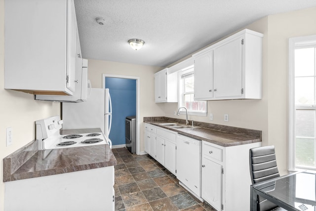 kitchen featuring a textured ceiling, white cabinetry, sink, and white appliances