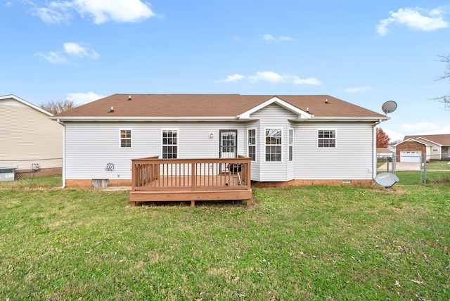 back of property with a deck and a lawn