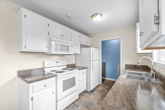 kitchen featuring a textured ceiling, white cabinetry, white appliances, and sink