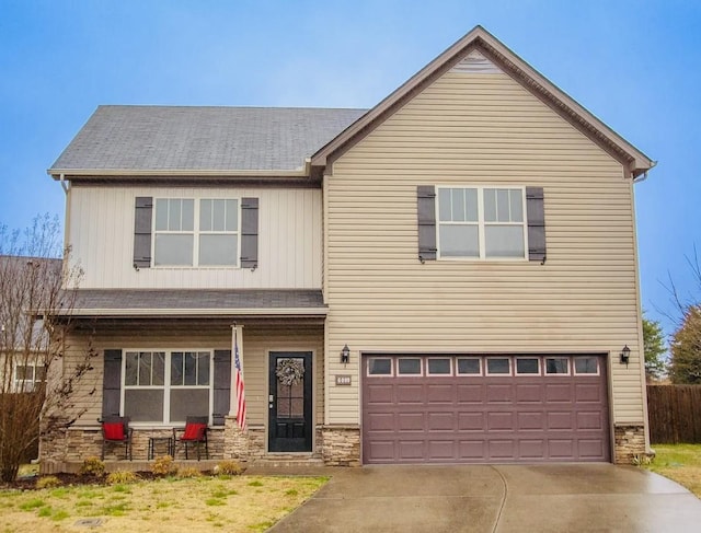 6009 Ten Bears Way, Spring Hill, TN 37174 - view of front of home with a porch, stone siding, driveway, an attached garage, and board and batten siding