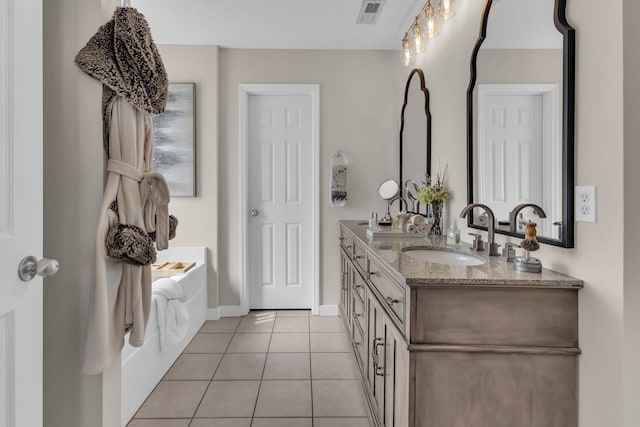 bathroom with tile patterned flooring and vanity