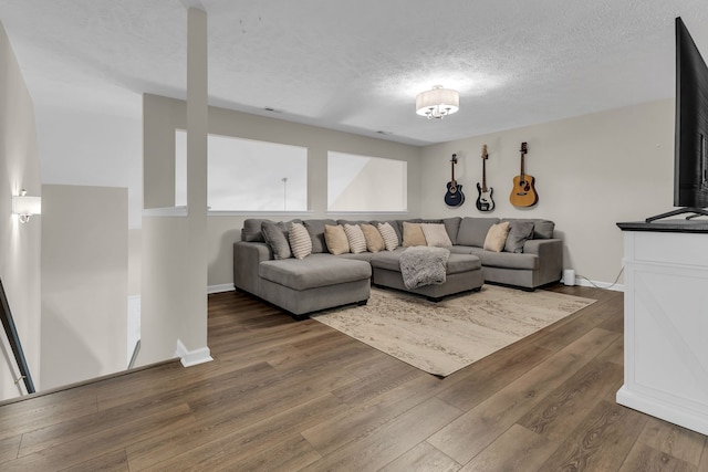 living room with dark hardwood / wood-style floors and a textured ceiling