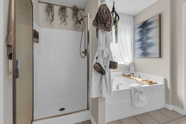 bathroom with tile patterned floors and shower with separate bathtub