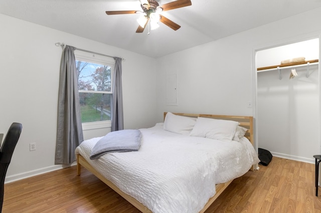 bedroom featuring a closet, light hardwood / wood-style floors, and ceiling fan