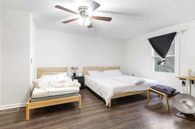 bedroom featuring ceiling fan and dark hardwood / wood-style floors