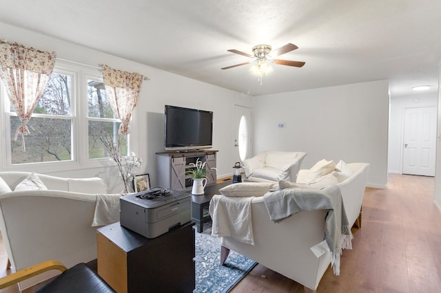 living room with hardwood / wood-style floors and ceiling fan