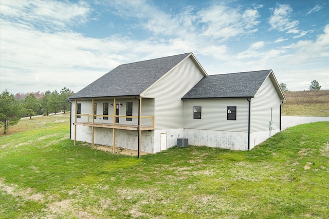 back of property featuring a yard, central AC, and a wooden deck