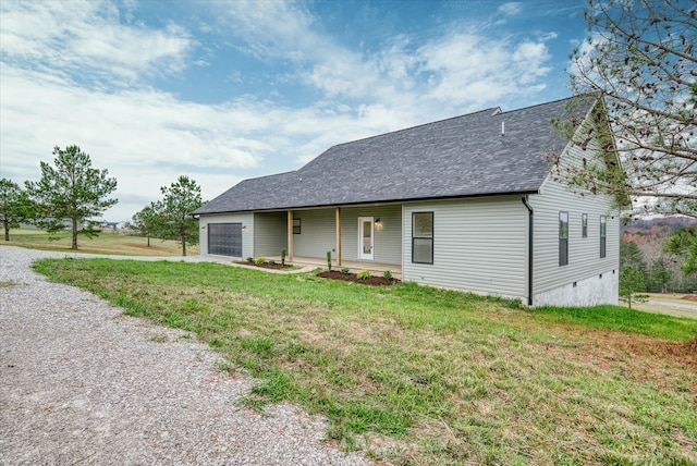 view of front of property with a front yard and a garage