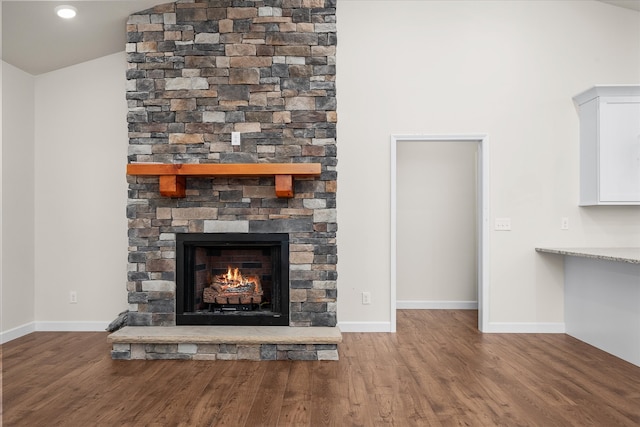 room details featuring hardwood / wood-style floors and a stone fireplace