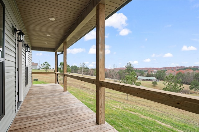 wooden terrace featuring a yard