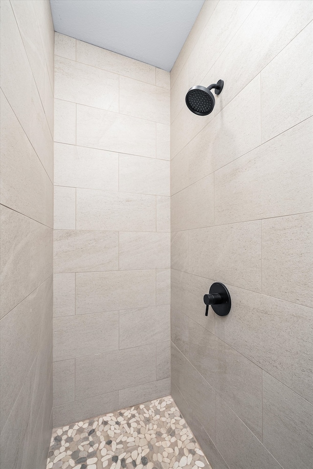 bathroom with tiled shower