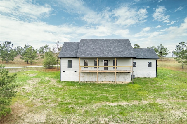 back of property featuring a lawn