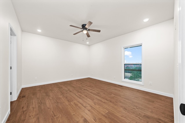 spare room with wood-type flooring and ceiling fan