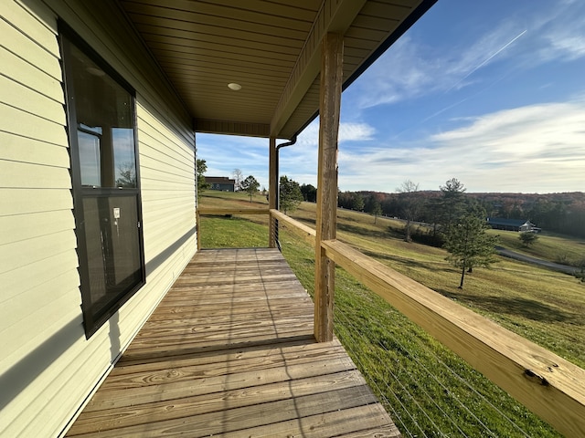 wooden terrace with a yard