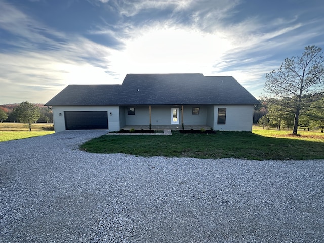 ranch-style house with a front yard and a garage