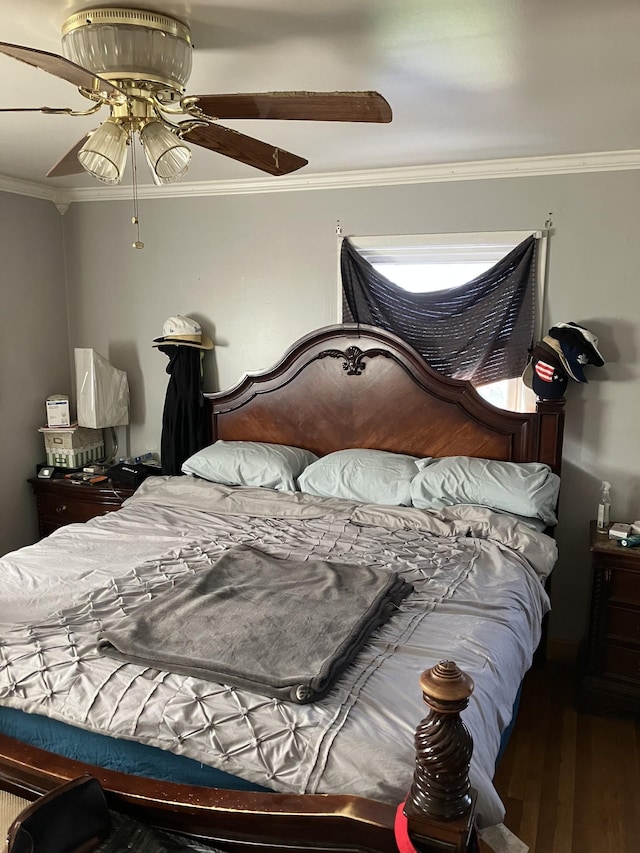 bedroom with ceiling fan, crown molding, and hardwood / wood-style flooring