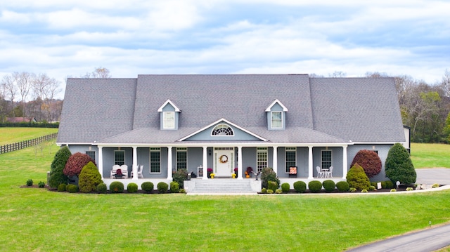 cape cod-style house with a porch and a front yard