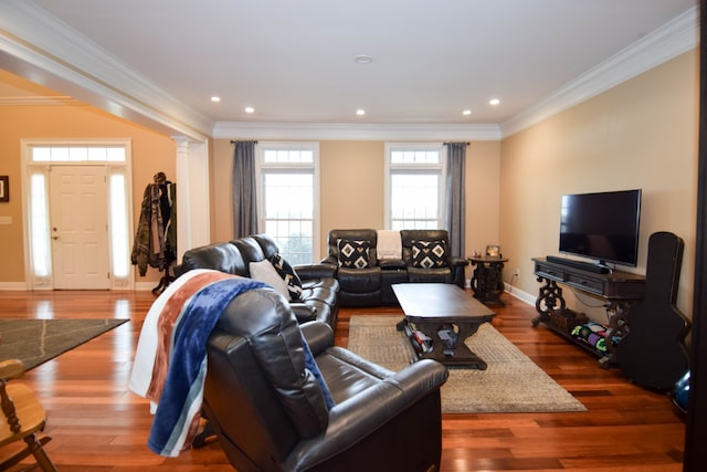 living room with ornamental molding, decorative columns, and hardwood / wood-style flooring