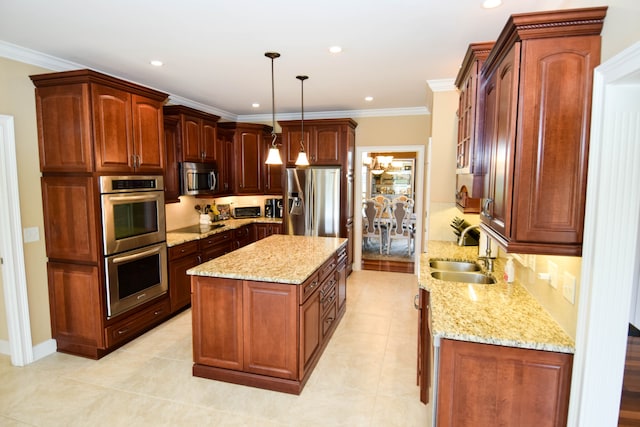 kitchen featuring decorative light fixtures, stainless steel appliances, crown molding, and sink