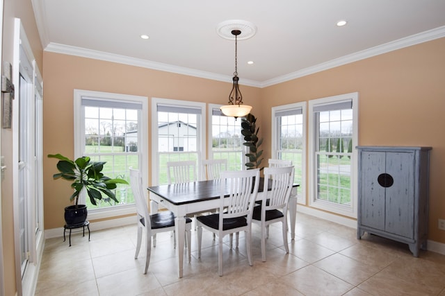 tiled dining room with ornamental molding and a wealth of natural light