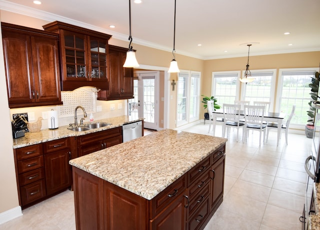 kitchen with sink, a center island, ornamental molding, stainless steel dishwasher, and pendant lighting