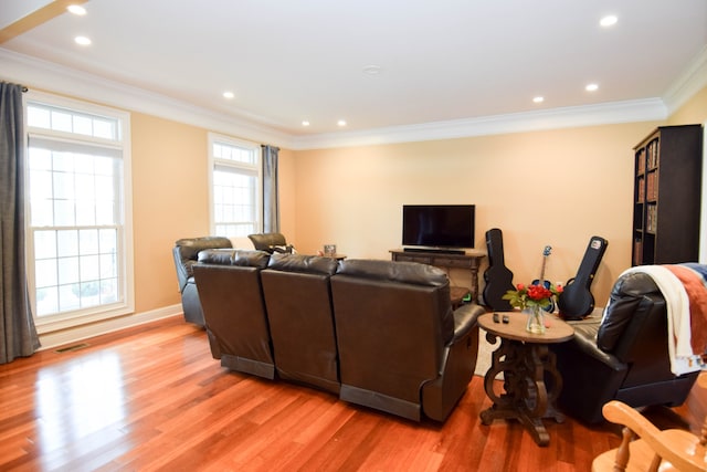 living room featuring light wood-type flooring and ornamental molding