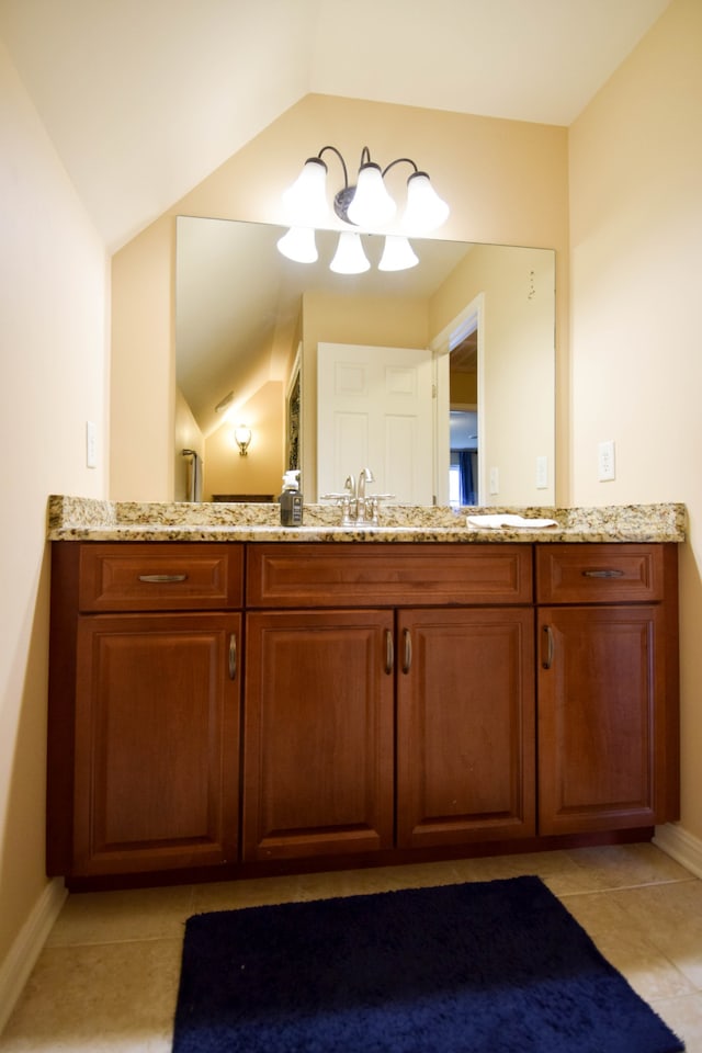 bathroom featuring lofted ceiling, tile patterned floors, and vanity