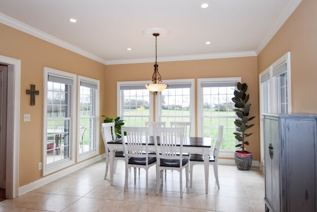 dining area with ornamental molding, plenty of natural light, and light tile patterned floors