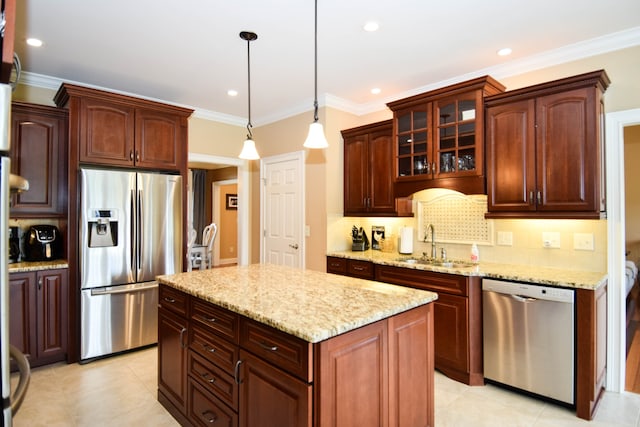 kitchen with stainless steel appliances, a kitchen island, decorative light fixtures, and sink